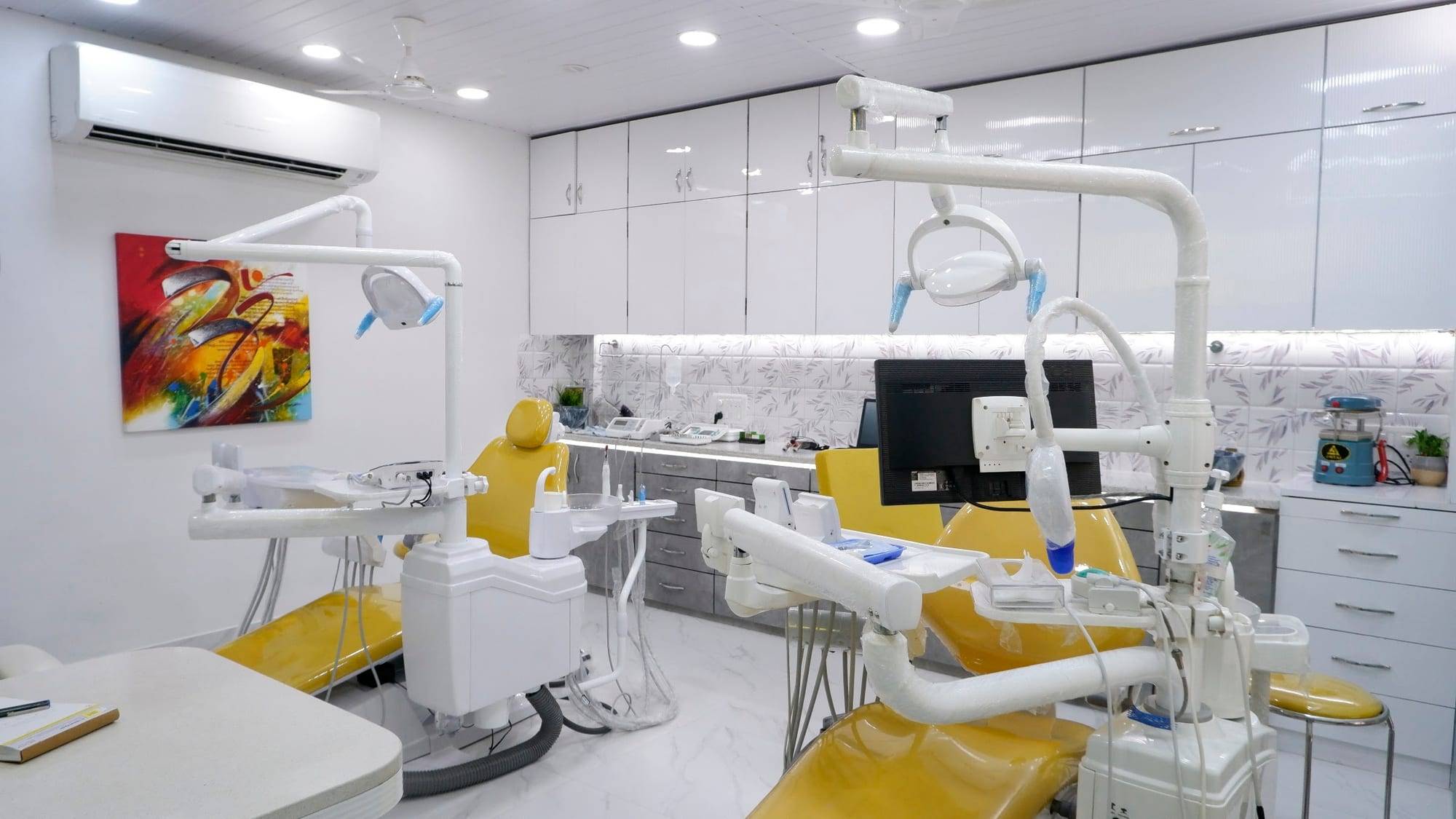 The treatment room, with two treatment areas and yellow dental chairs