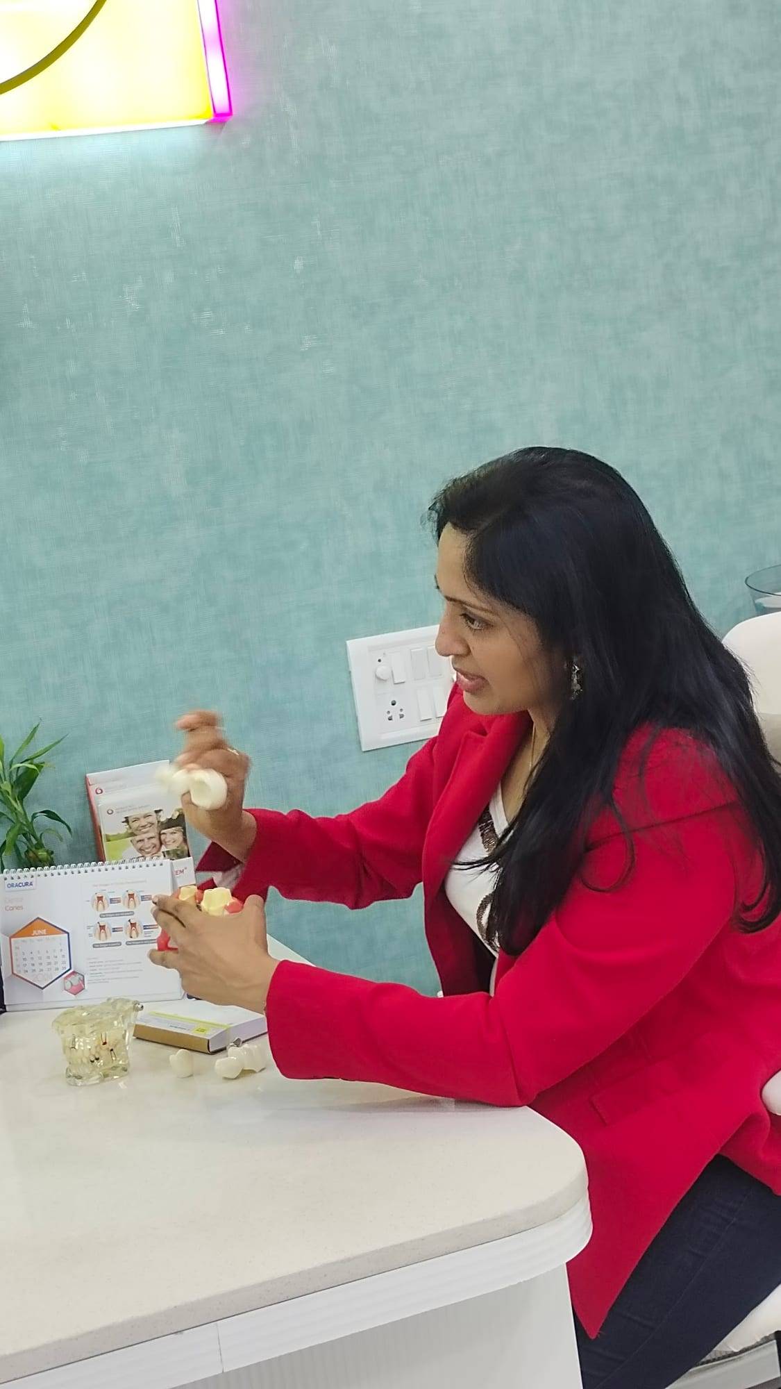 Dr. Vaishali explaining treatment using dental models